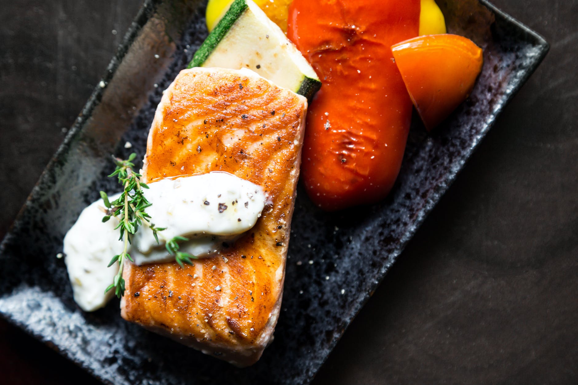 grilled salmon fish on rectangular black ceramic plate